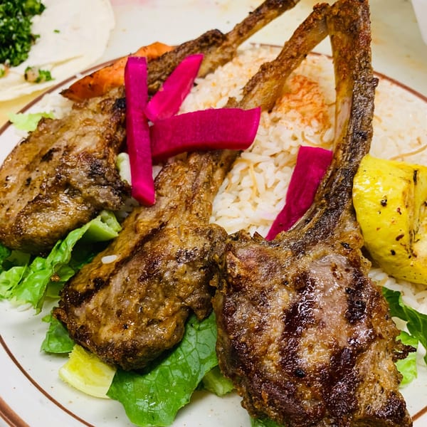 Le Kabob's grilled lamb chops with rice, pickled turnips, and lettuce.